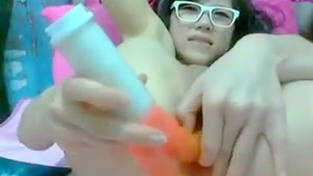 Nerdy webcam Asian stuffing her pussy with dildos on cam