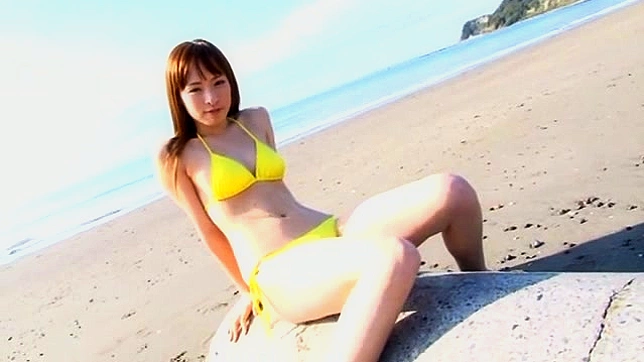 This vexing and daring asian girl in bikini is posing outdoors