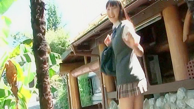 魅惑的でキュートな女子学生が屋外でポーズをとっている。