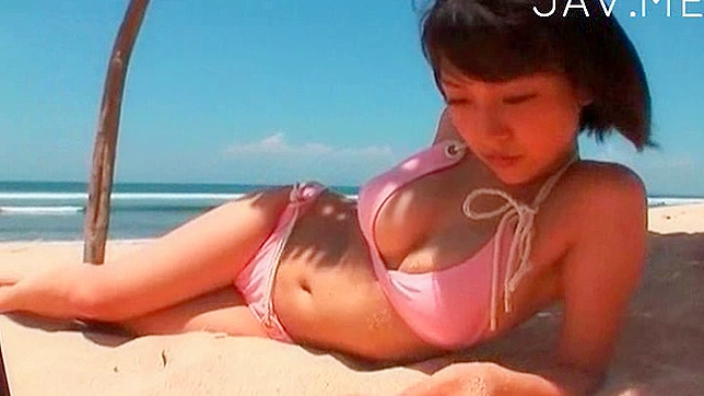 Handsome and foxy asian teen in bikini is posing on the beach