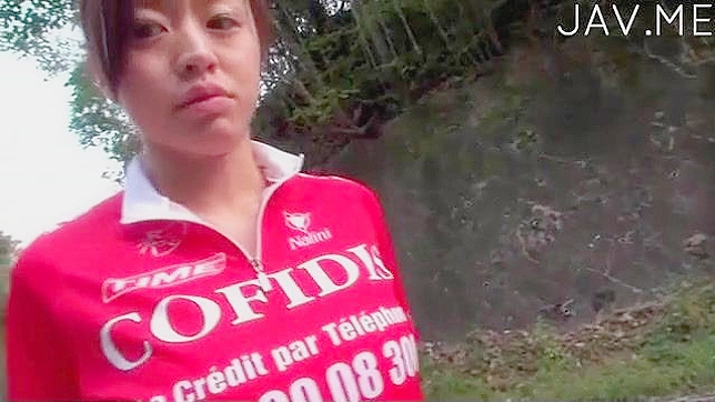 Sporty and sexy japanese teen is riding on bicycle outdoors