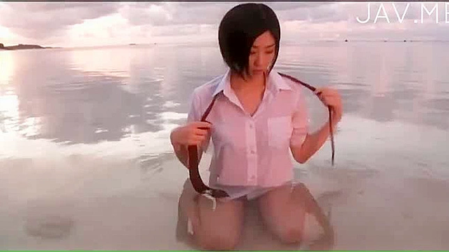 Attractive and sexy japanese solo teen is posing in the water