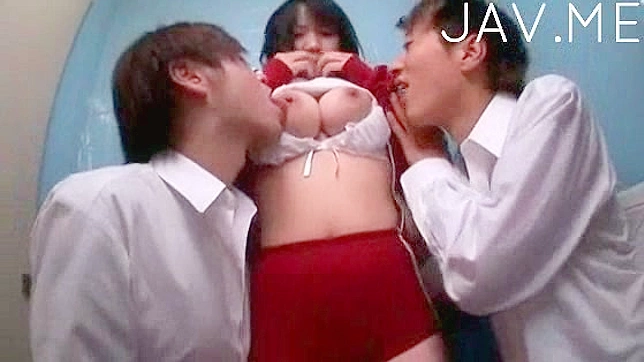 Japanese chick lets two studs suck her tits simultaneously