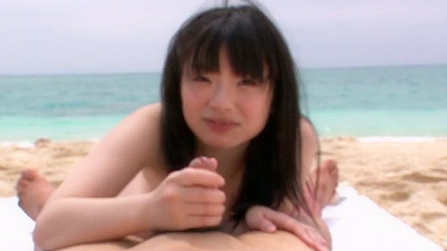 Japanese doll with dark hair is giving blowjob on the beach