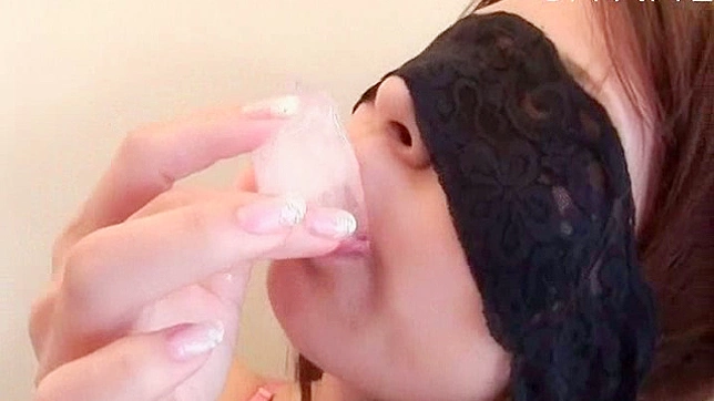 Asian darling is getting wet from sucking on a lollipop