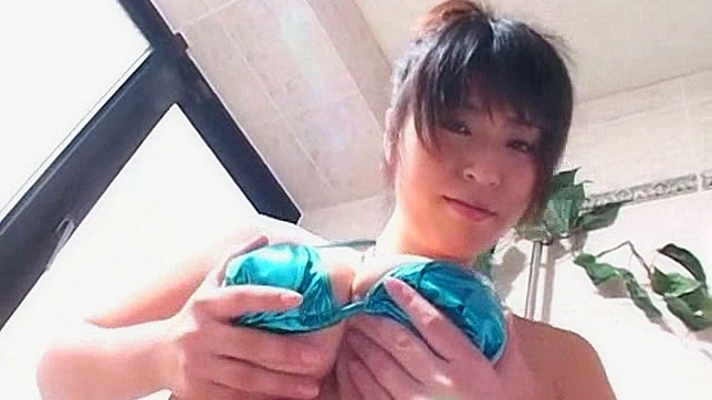 Busty japanese angel in bikini is playing with her melons