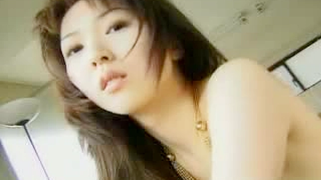 Sexy Asian teen showing off her perky titties