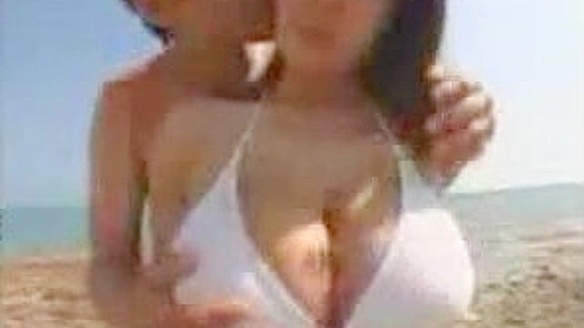 Sexy JAV Babe Shows Off Huge Tits on Sandy Beach