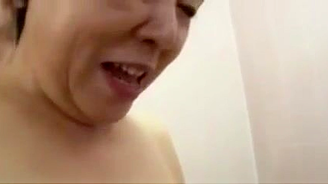 Busty Japanese Granny with Anal Toy in Public Toilet