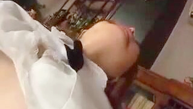 Japanese maid in bondage ruins hard dick on the table with her mouth.