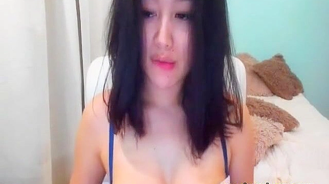 Witness the Sensual Tease of an Alluring Asian Brunette on Cam!